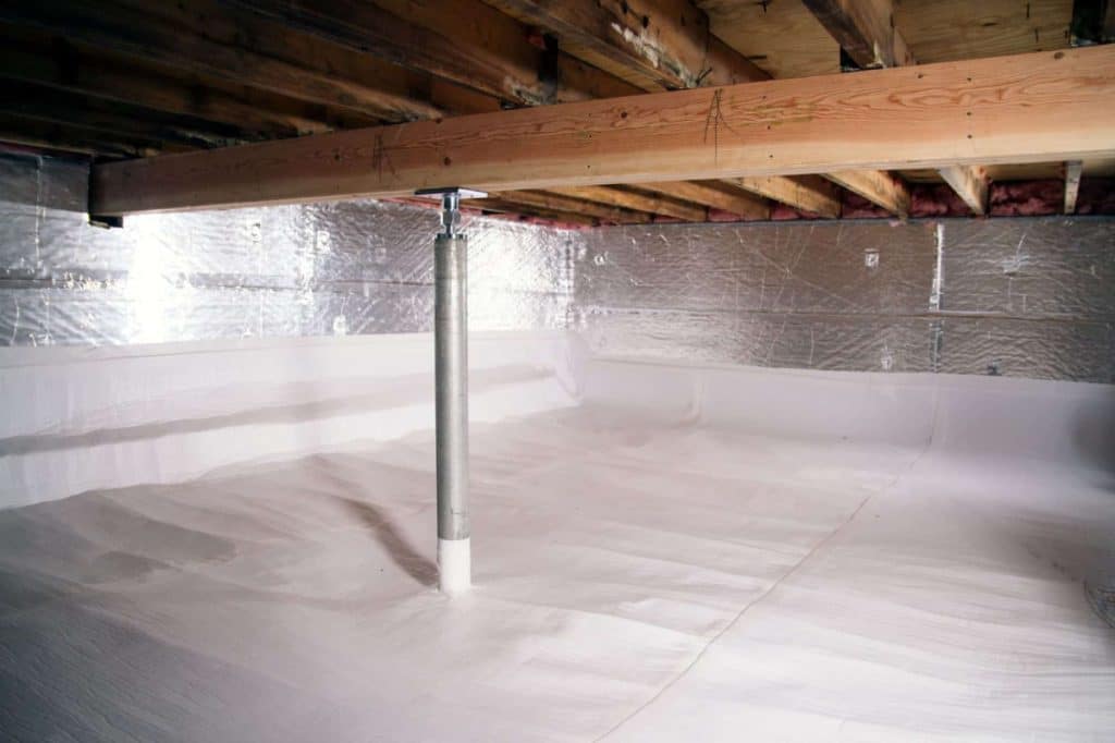 Clean, well-lit basement crawl space with wooden beams above, metallic insulation on the walls, and a supporting metal post. The area looks organized and dry.