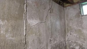 Cracked basement wall showing signs that foundation repair may be needed in a Michigan home